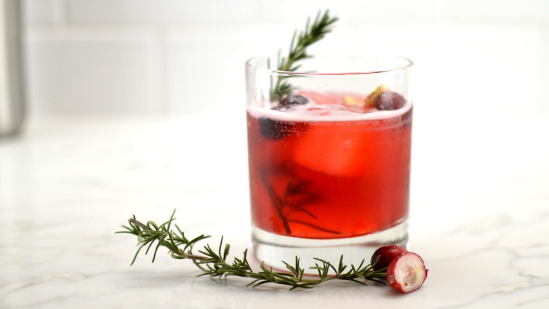 glass of cranberry ginger kombucha mocktail