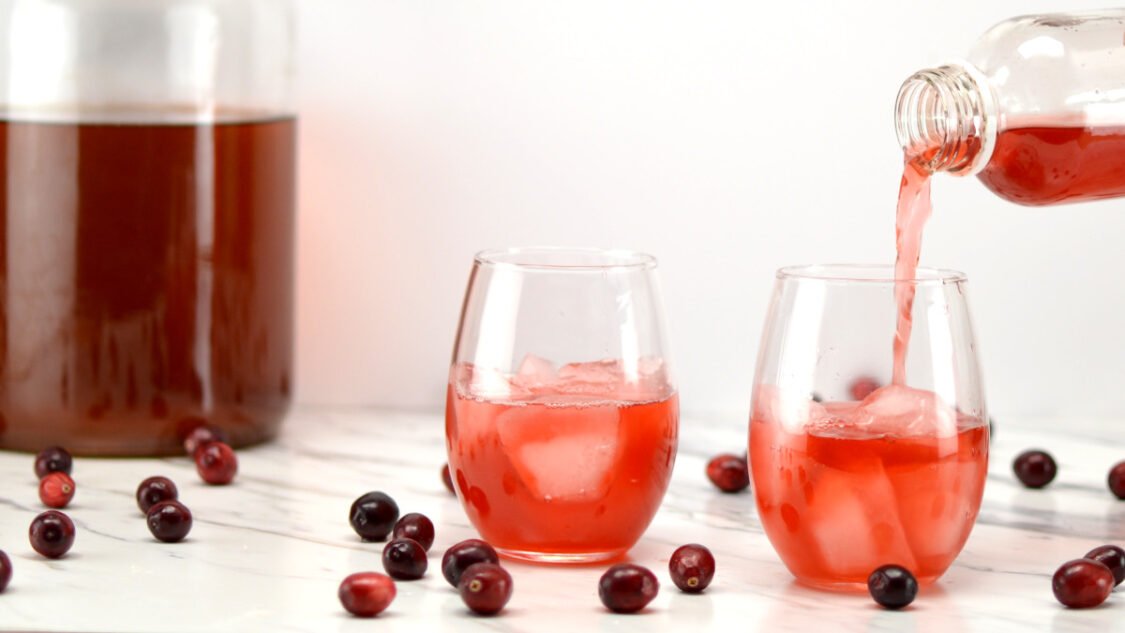 pouring cranberry kombucha