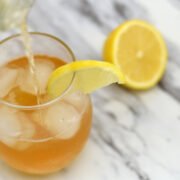 pouring lemon kombucha into glass