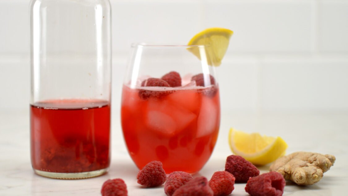 glass and bottle of raspberry gingerade kombucha