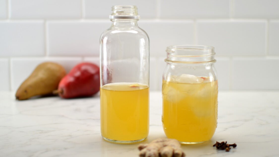 glass and bottle of spiced pear kombucha