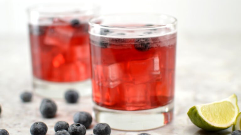 glass of blueberry collins kombucha mocktail