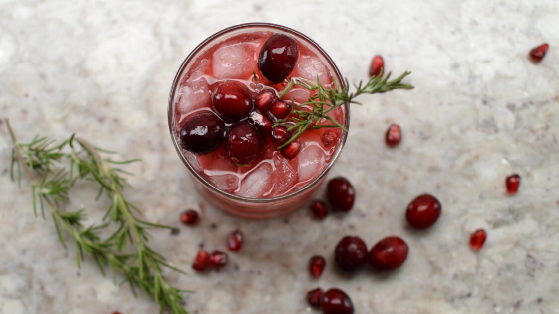 glass of cranberry pomegranate kombucha mocktail