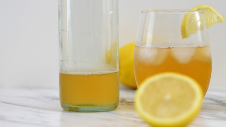 glass of lemon kombucha and bottle