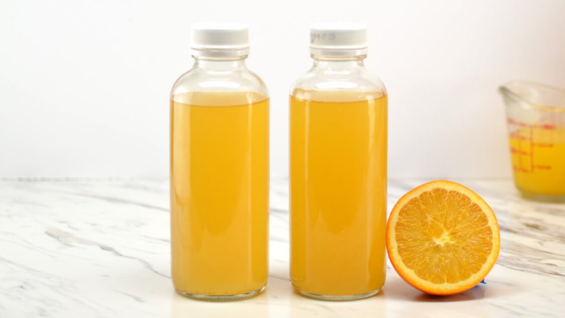 two bottles of orange creamsicle kombucha