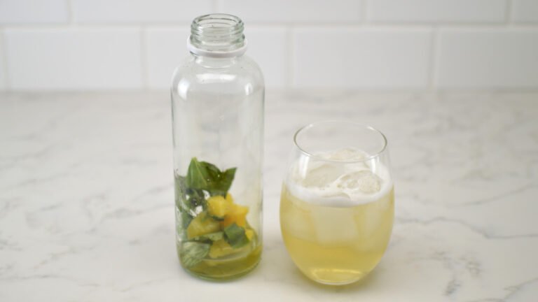 bottle and glass of green tea pineapple basil kombucha