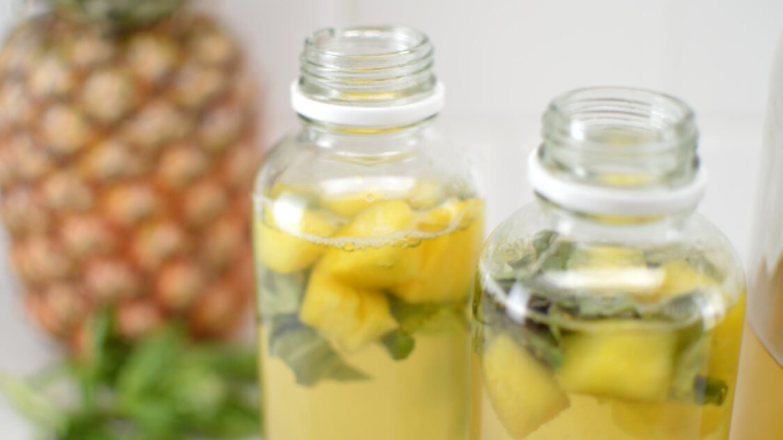 close up bottles of green tea pineapple basil kombucha