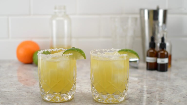 two glasses of orange lime kombucha margarita mocktail