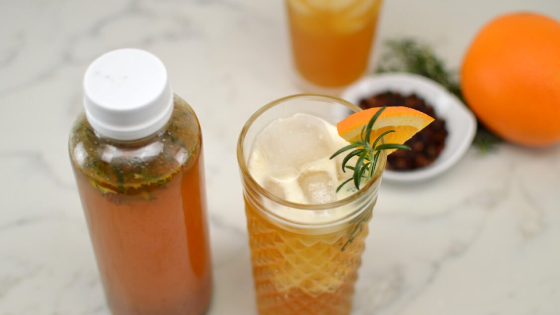 bottle and glass orange rosemary rose hip kombucha - top